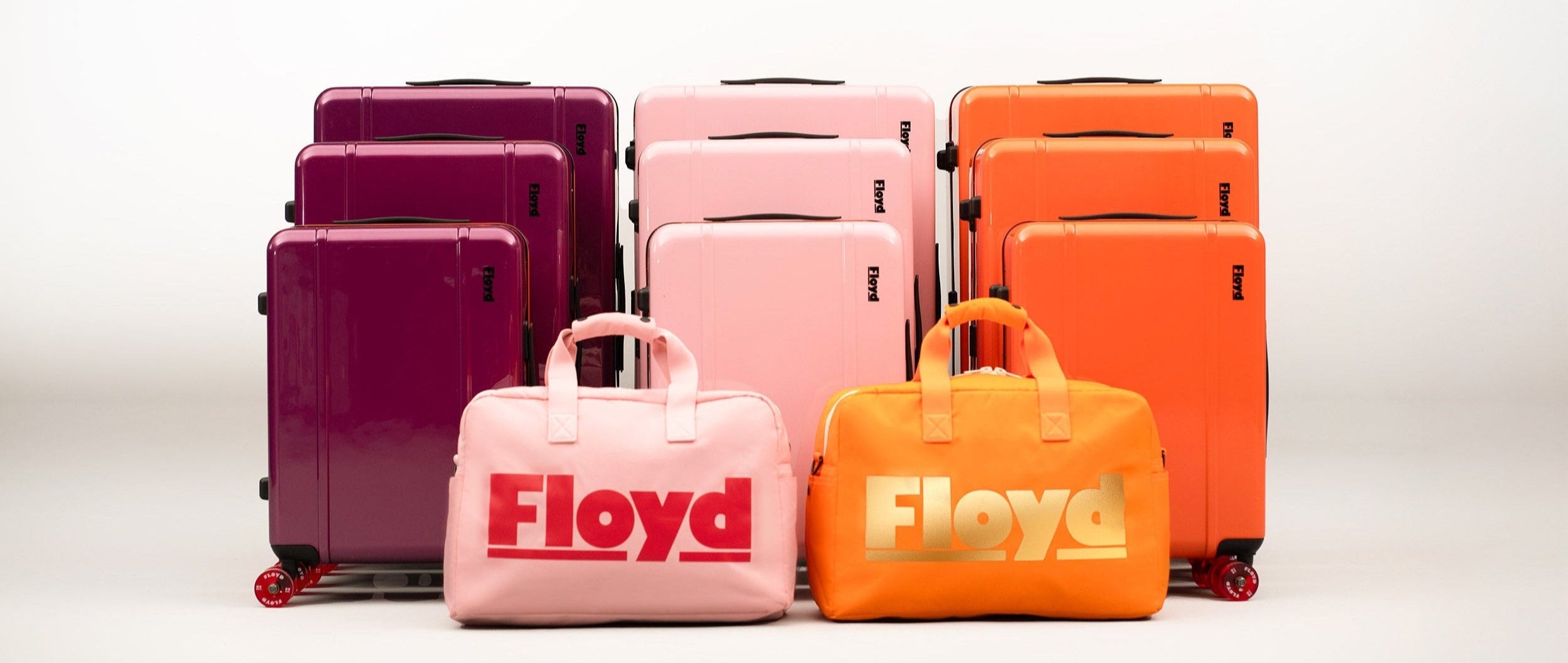 Set of colorful suitcases with 'Floyd' branding on a white background