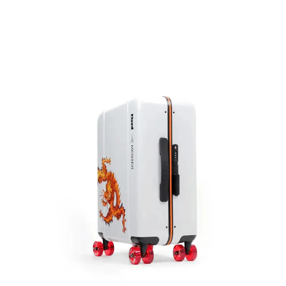 Three-quarter view of the Floyd x Meissen Cabin suitcase with orange dragon artwork