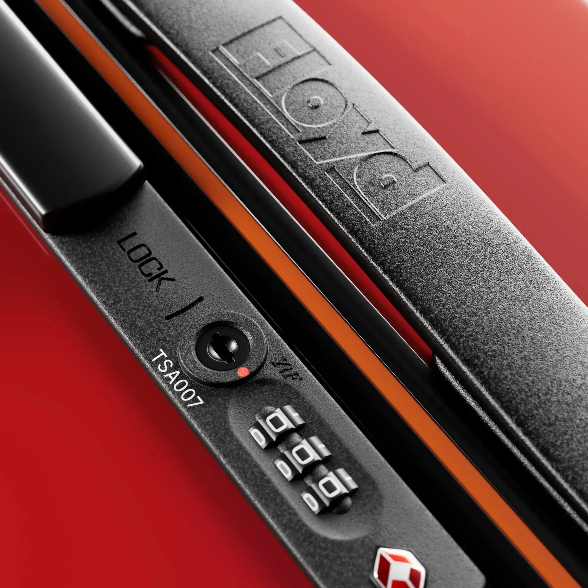 TSA combination lock detail on the Floyd Check-In suitcase in Bahia Red