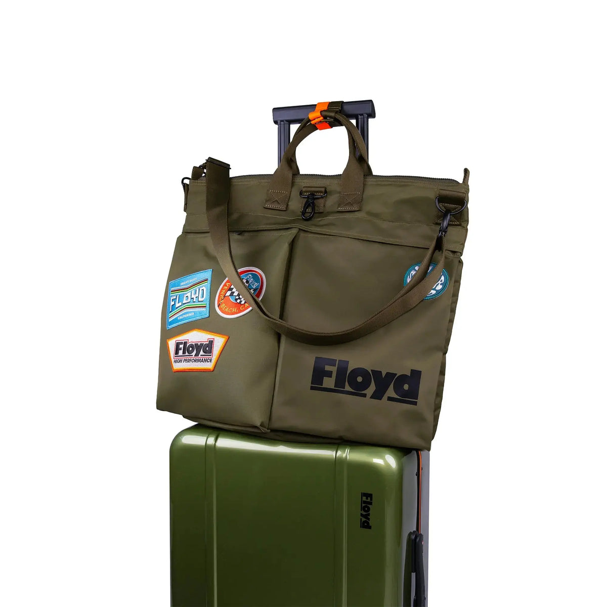 Floyd Helmet Bag in Gator Green attached to a Floyd suitcase