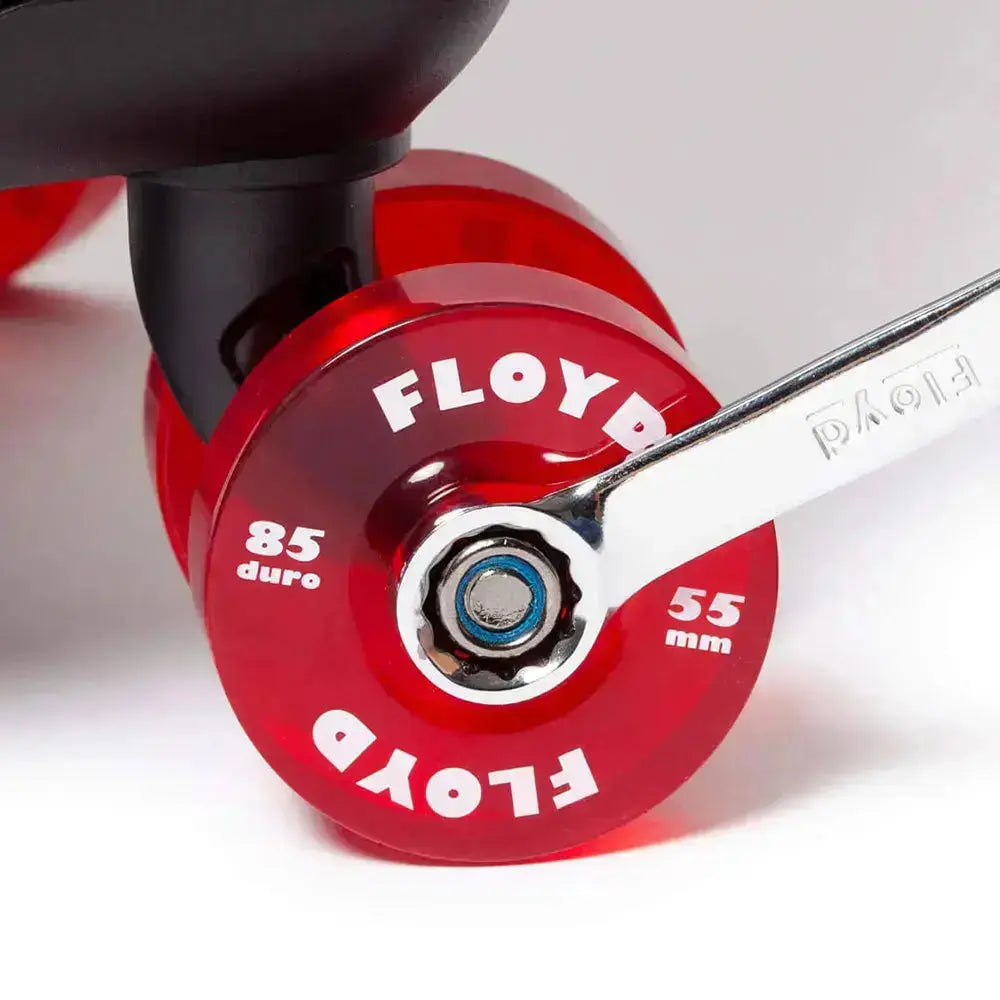Close-up of a red Floyd suitcase wheel with maintenance tool