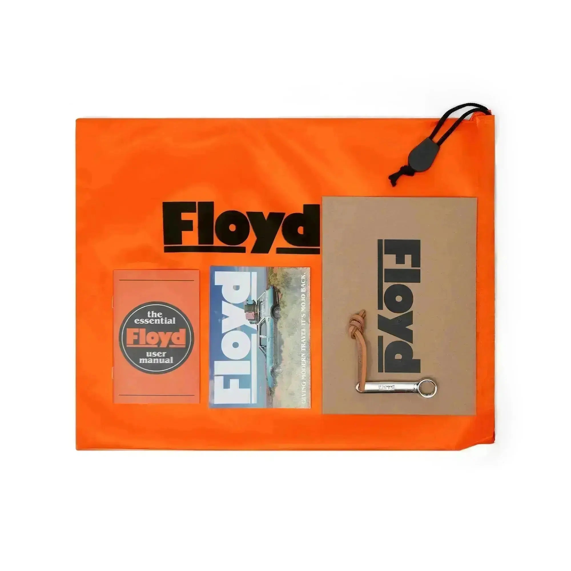 Included Floyd travel case accessories with orange duster, manuals and wheel tool
