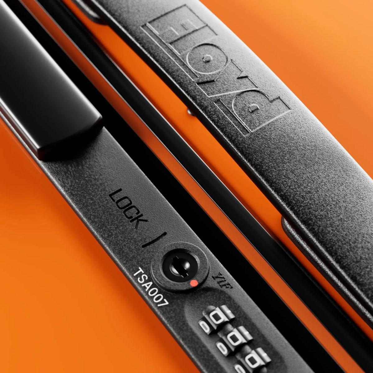 TSA combination lock detail on the Floyd Trunk suitcase in Hot Orange